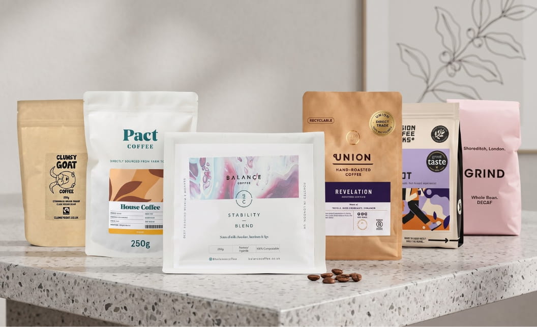 Six coffee packs on a tabletop with Balance Coffee centered.