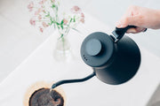 Man pouring coffee with a drip fit